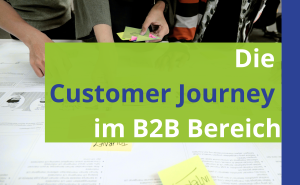 Titel im Vordergrund in blau und weiß auf einem grünen Feld und dann im Hintergrund ein Schreibtisch, an dem Mitarbeiter eine Customer Journey planen und besprechen.